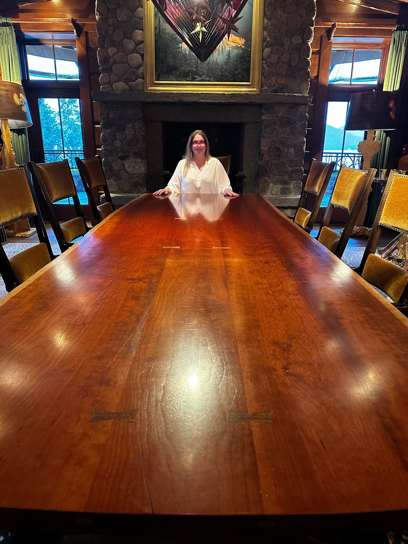 Marcy sitting alone at a large conference table 