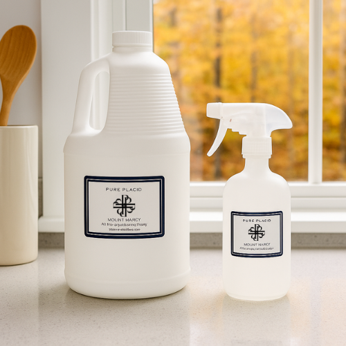 Two white bottles with labels on a kitchen counter with a window in the background.